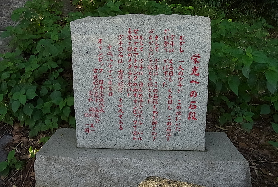 画像:古賀稔彦氏を称える「栄光への石段」石碑