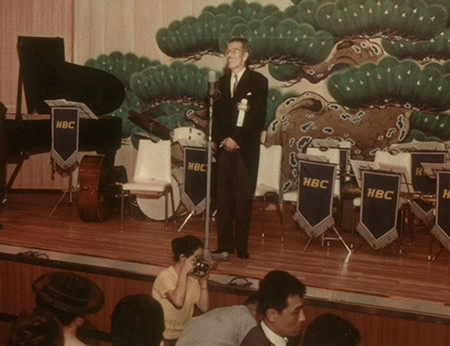画像：1964年(昭和39)ホテル三愛の開業披露宴で挨拶する市村